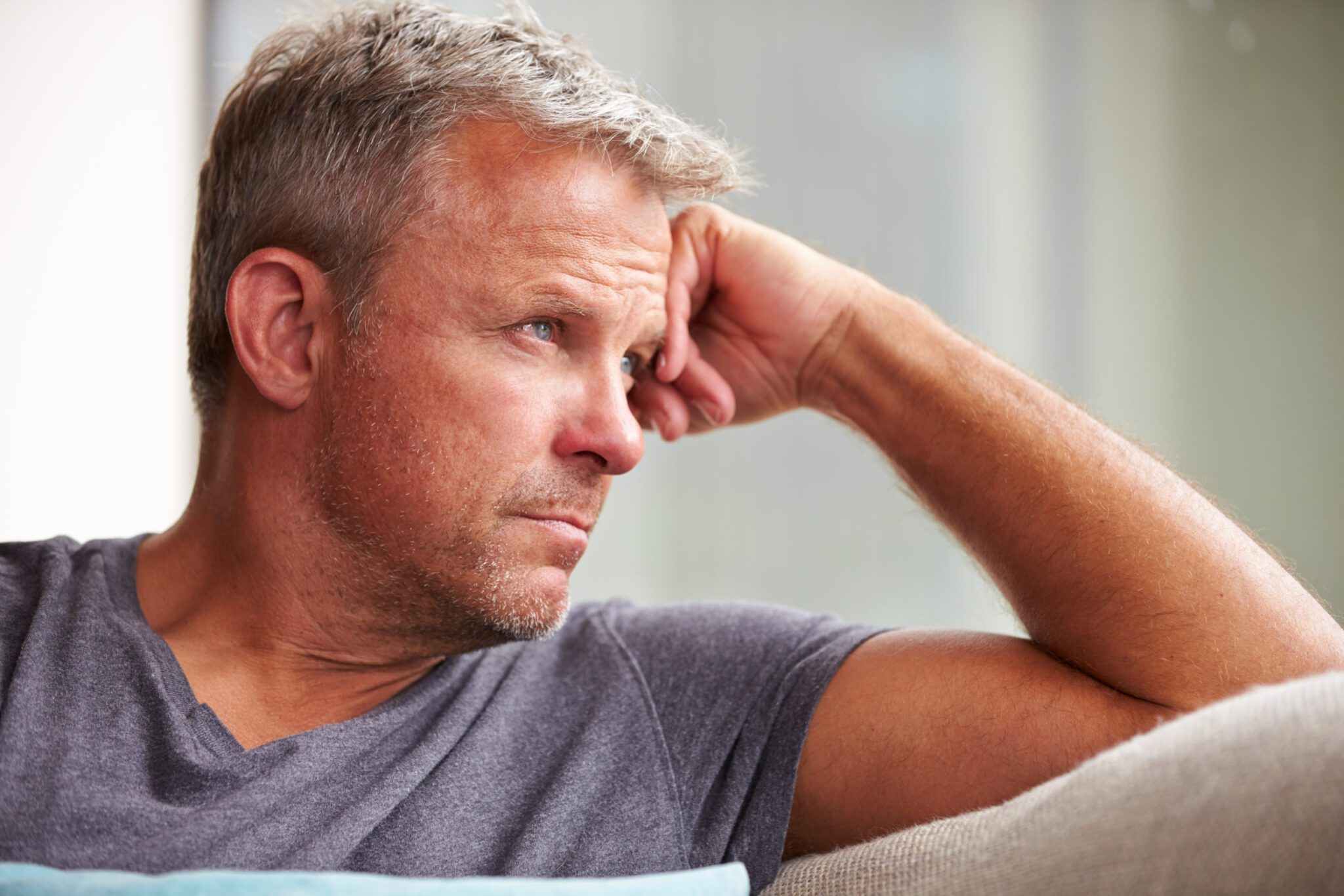 Stock image of Male distressed looking away from the camera to represent men in therapy